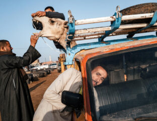 photo by Jonathan Jasberg, people with a car and a camel