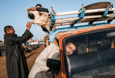 photo by Jonathan Jasberg, people with a car and a camel